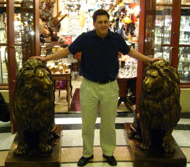 Brian poses with some lion statues.