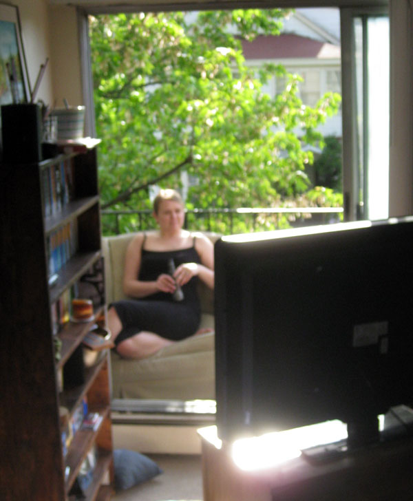 Lauren watches Twins Yankees on balcony.