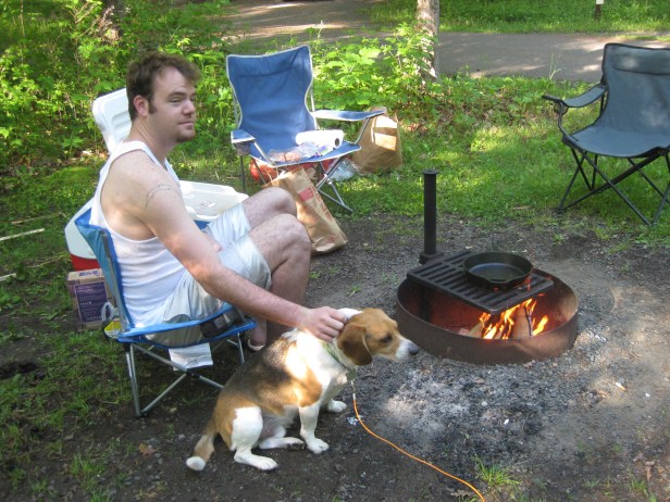 Ryan and Roscoe the beagle cook breakfast by campfire.