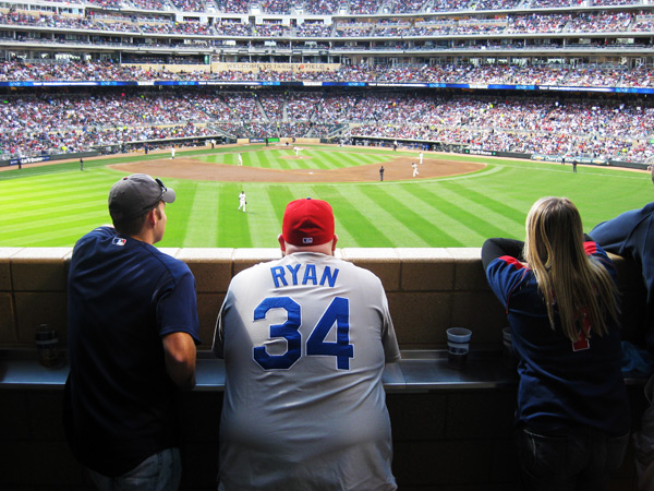 Patrick, Colin, and Lauren look on from the center field standing room section.