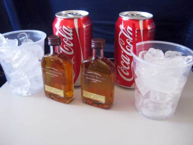 Drinking whiskey Cokes on the airplane