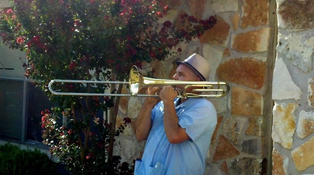 Mark Addison playing trombone at garage sale