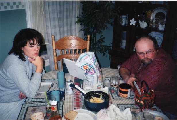 Mom and Dad zone out watching the news during dinner.