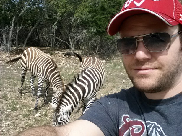 Here's me with some zebras. I threw them some pellets to eat and they ate them and everyone was merry.