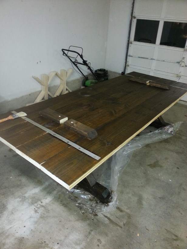 The bottom of the table with a coat of stain on it.