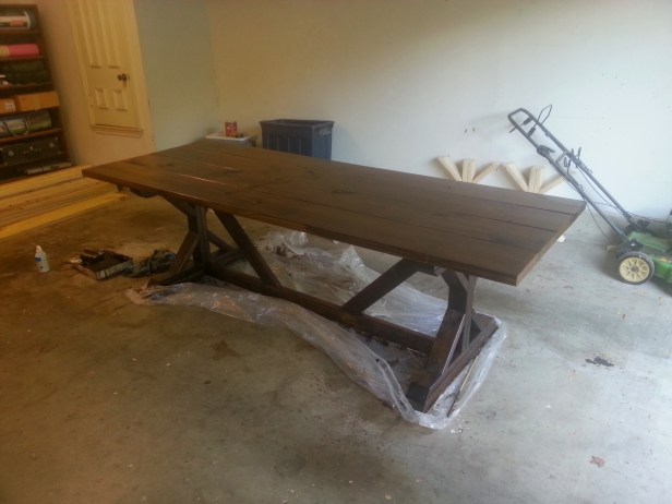 The table top carefully turned over and placed on its base, then stained.