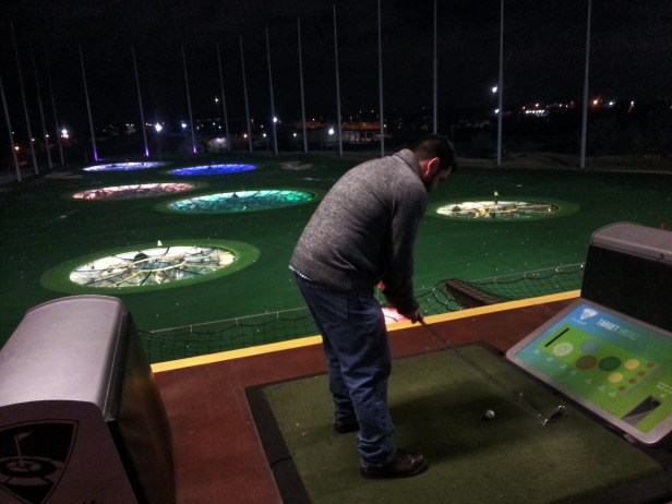 Co-worker Brian tees up from the third level.