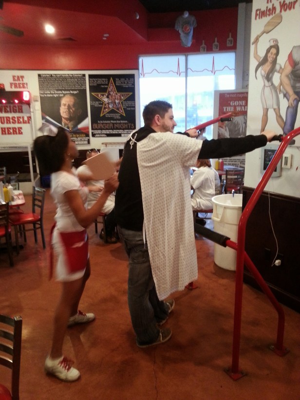 Jay getting spanked by the nurse waitress at Heart Attack Grill for not finishing his absurdly high-calorie food.