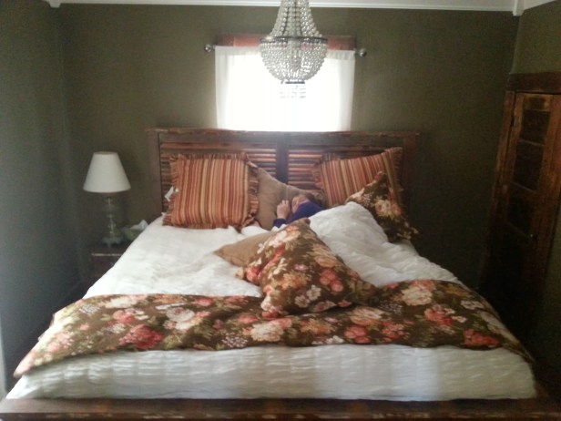Lauren buried under the pillows in our comfy B&B bed in Fredericksburg.