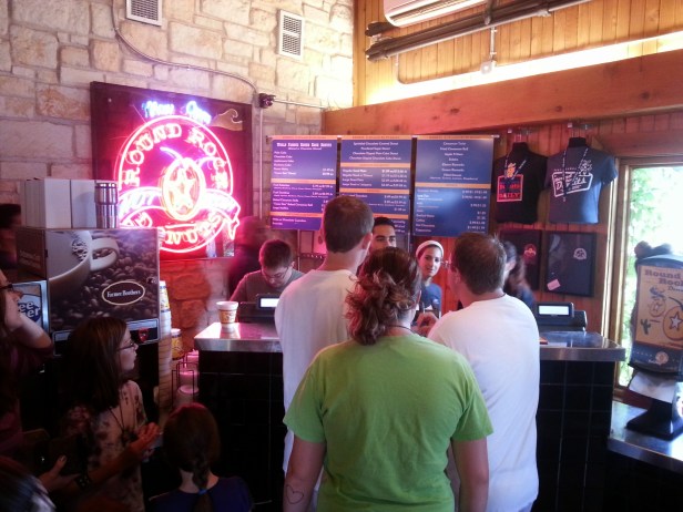 Waiting for my number to be called at Round Rock Donuts. We got a Texas-sized baked cinnamon roll, a dozen glazed donut holes, and a chocolate bavarian-filled roll... all for $3.57!