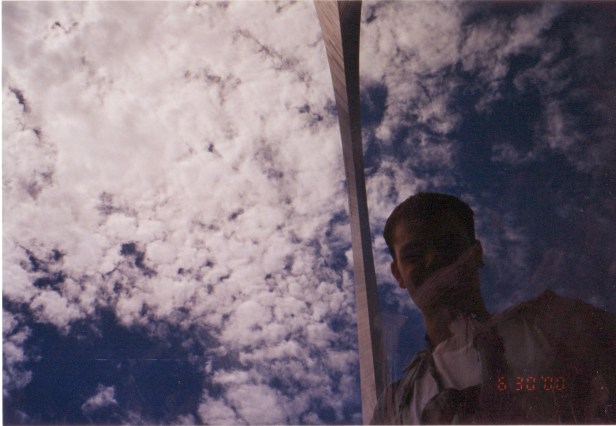 A wildly poor attempt at a 2000 selfie of me under the Gateway Arch.